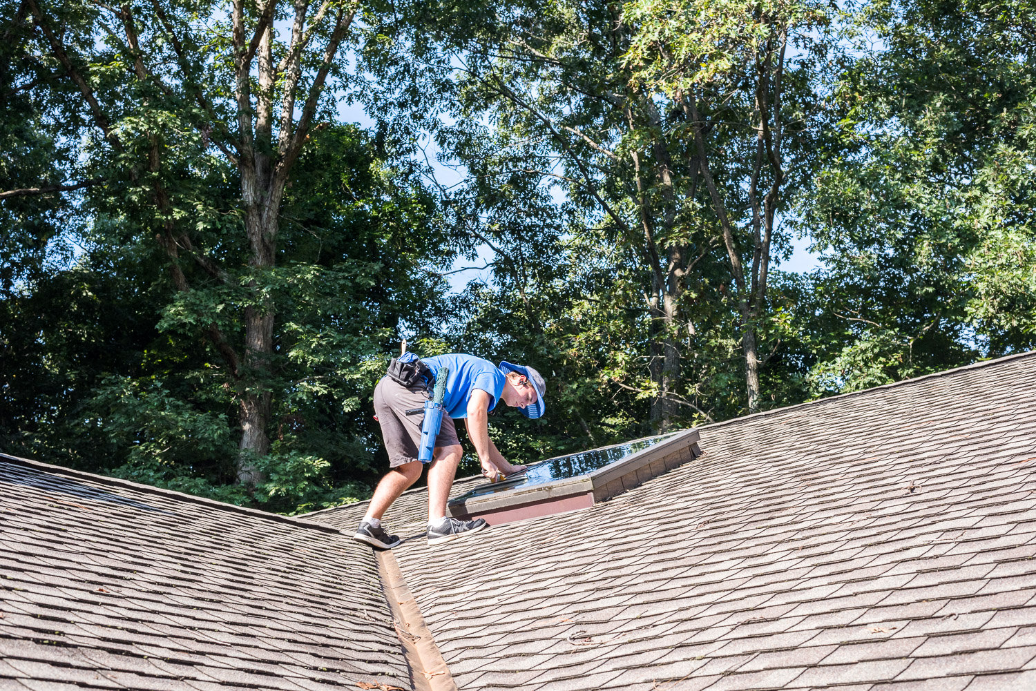 Crew cleaning a sky window on roof in Richmond, VA.